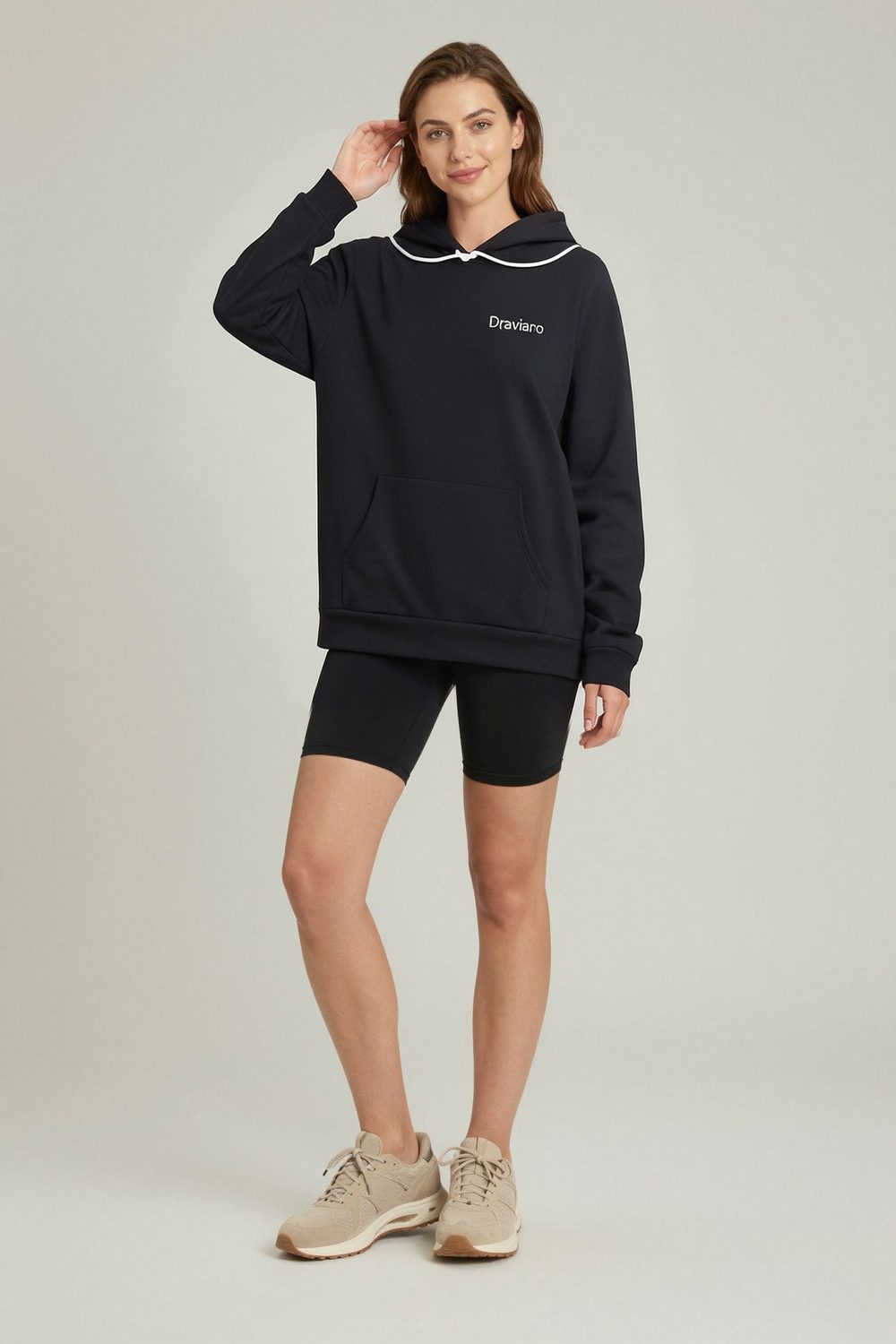 black hoodie on female model in rooftop evening setting professional fashion photography