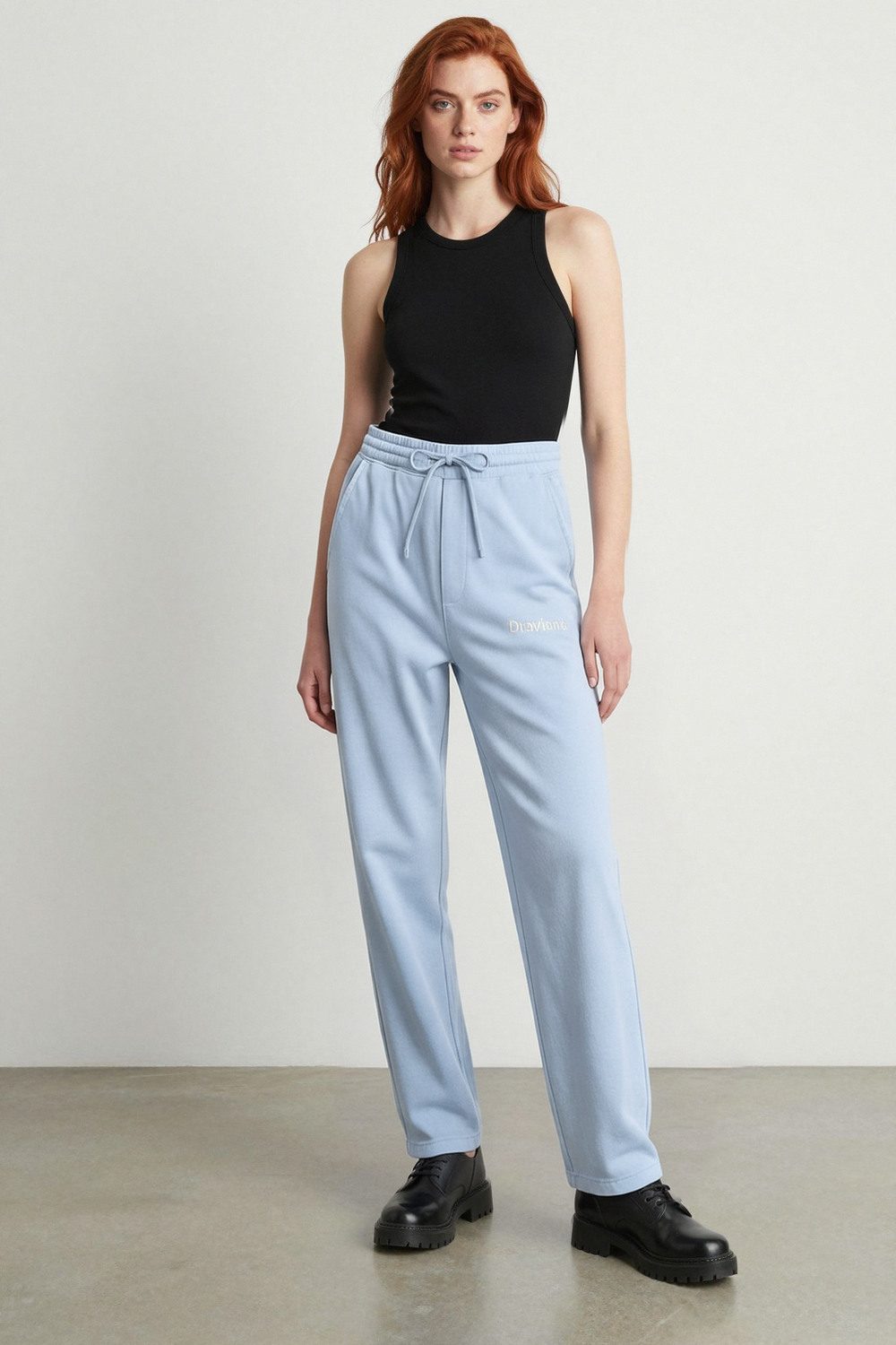 light blue joggers on female model in studio white setting professional fashion photography